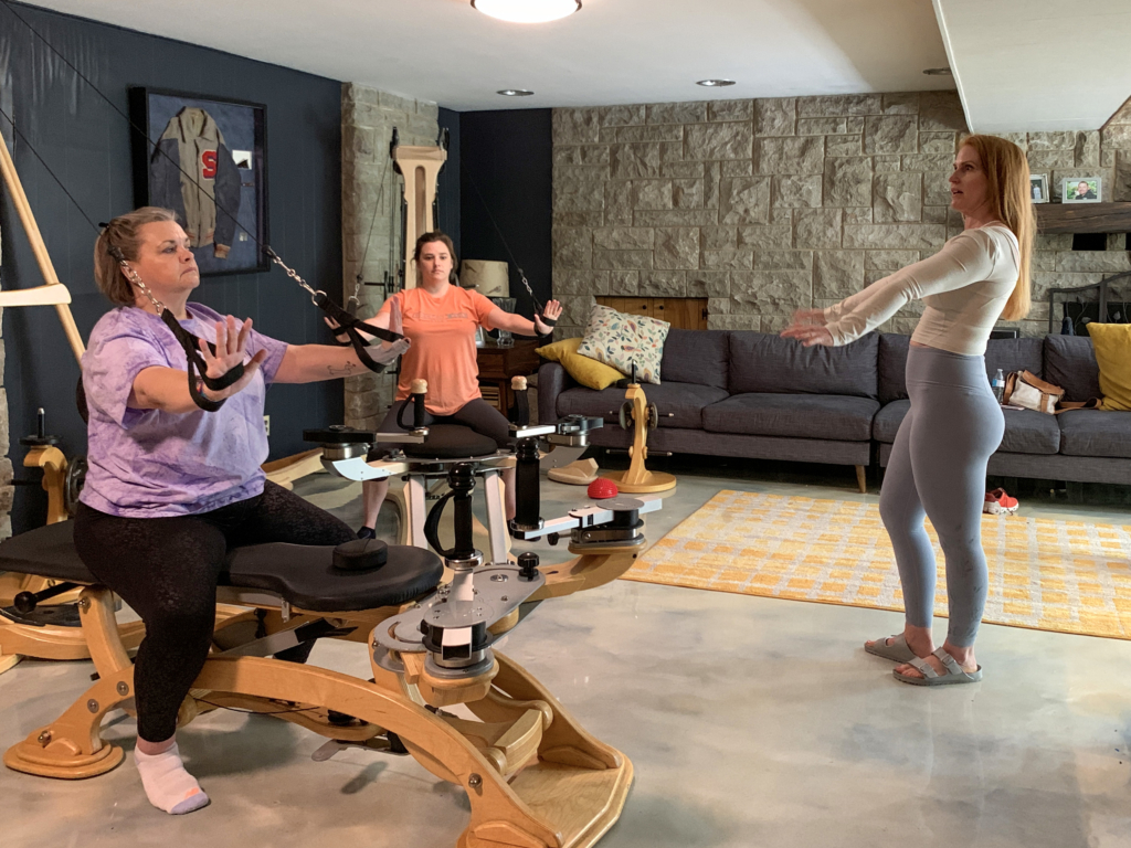 Chandler Moore, GYROTONIC® Trainer teaching with limitations to clients