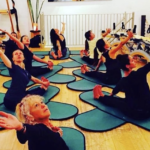 Master Trainer Miriam Barbosa leads a Gyrokinesis Class on mats.