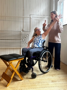GYROTONIC® and GYROKINESIS® Master Trainer Dana Gringas teaching a student in a wheelchair