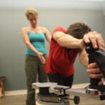 A Gyrotonic Trainer working with a client