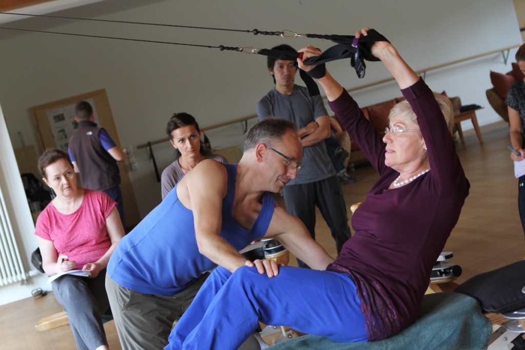 A Gyrotonic Trainer working with a client