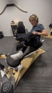 A woman exercising on a piece of Gyrotonic equipment, demonstrating the effectiveness of an inclusive studio for every body