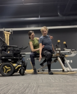 A woman in a wheelchair practicing an exercise on the Gyrotonic Pulley Tower Combination Unit