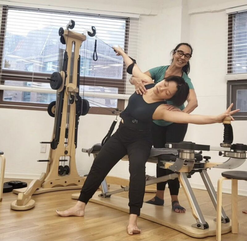A licensed GYROTONIC® Trainer working with a client on the GYROTONIC® Pulley Tower Combination Unit informed by Polyvagal Theory, whcih describes how the nervous system organizes experience through three primary states.
